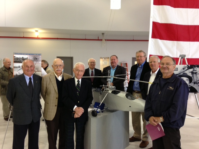Sikorsky Aircraft retirees gather around a 1/4 scale model of the VS-300